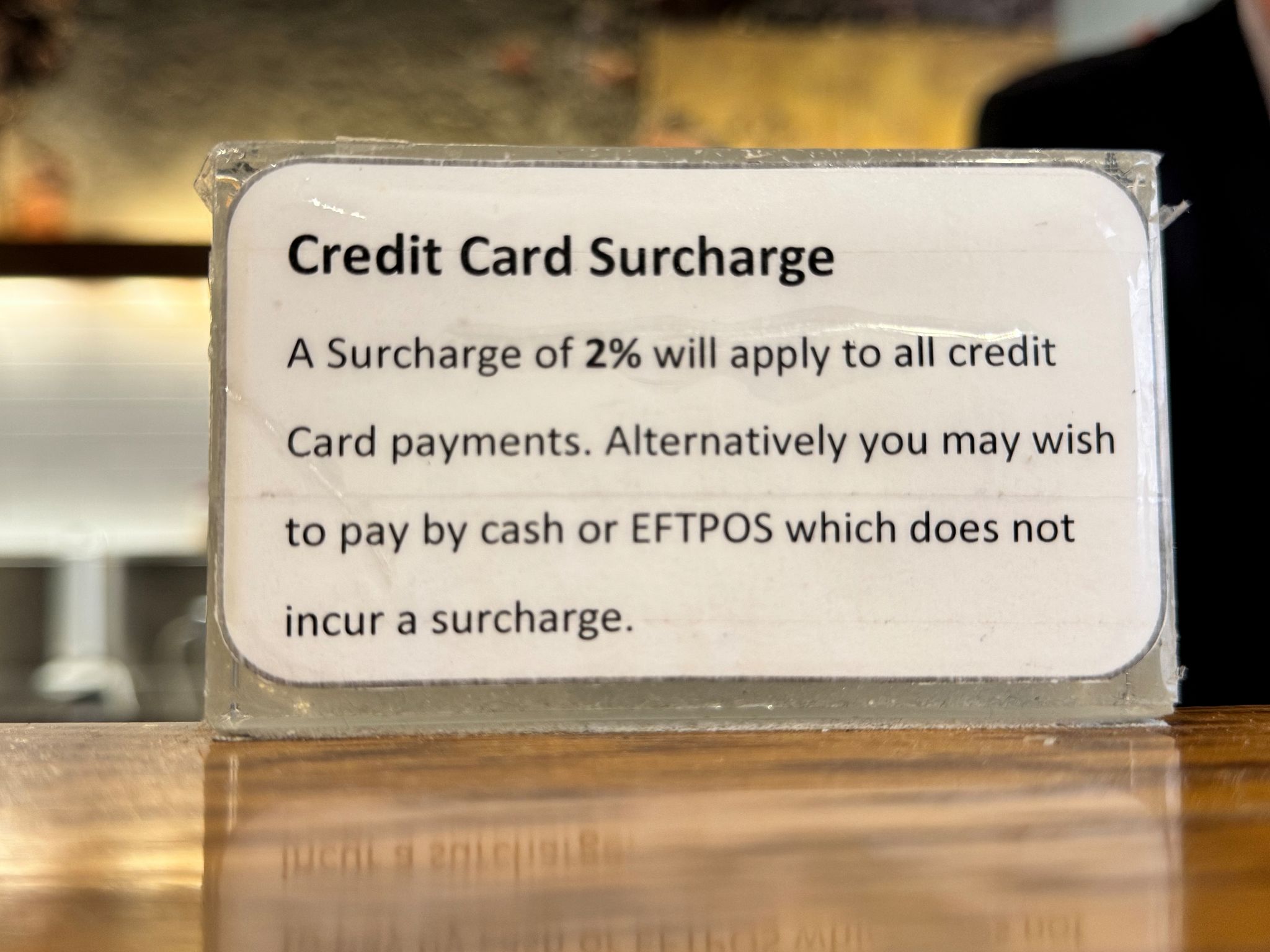 credit card surcharge sign at register