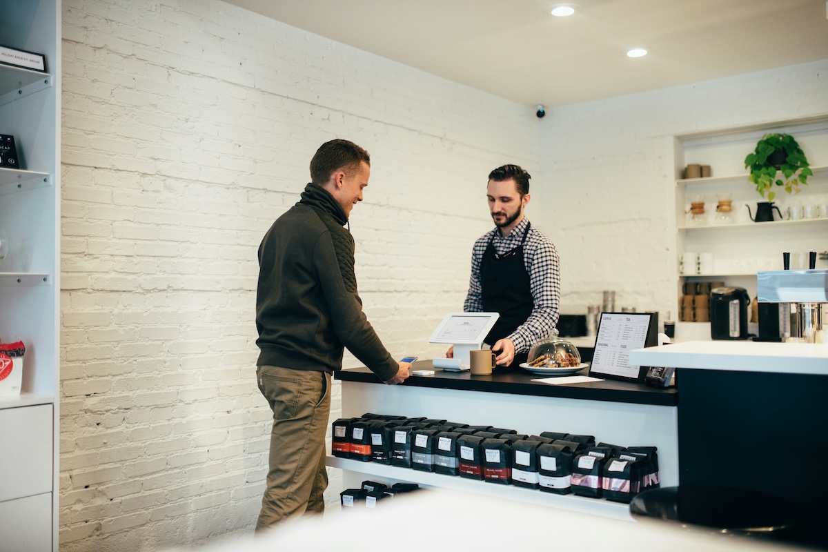 retail store owner accepting credit card payment