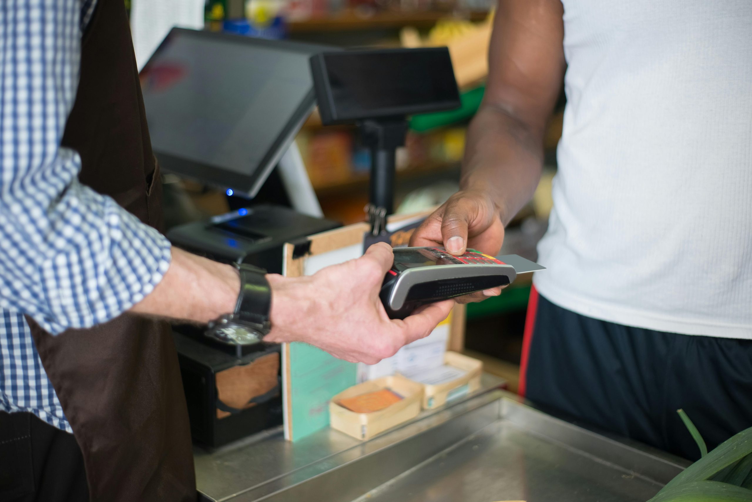 customer paying via eftpos terminal at local grocery store